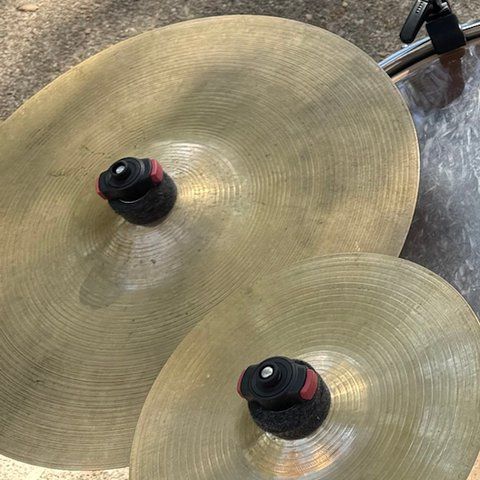 A large crash cymbal resting over the floor tom.