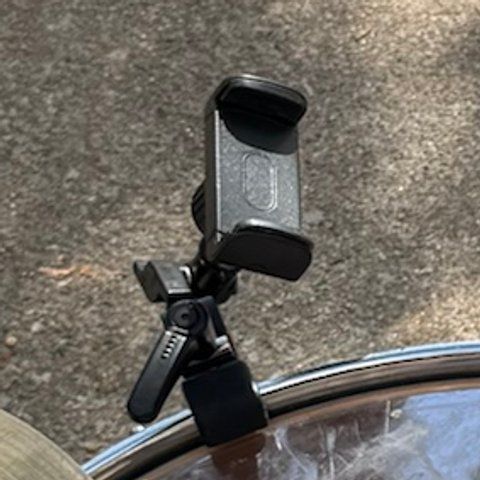 A clamp phone mount on a short arm, attached to a drum hoop.